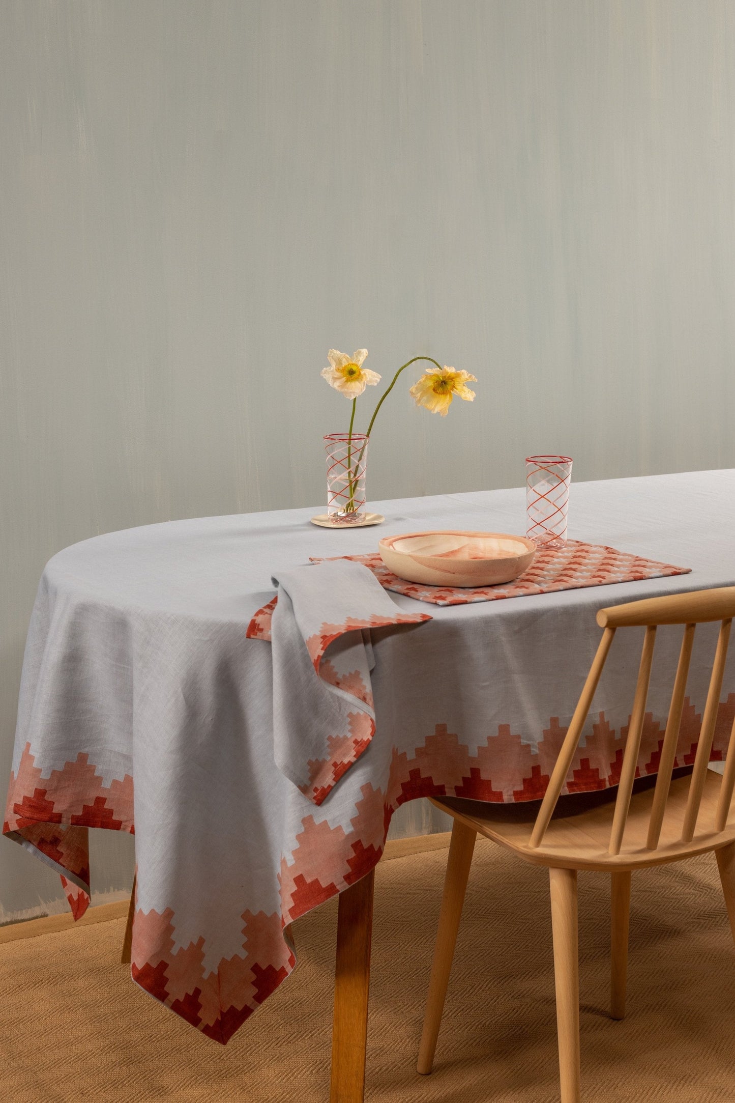 Blue tablecloth on a table with one place setting